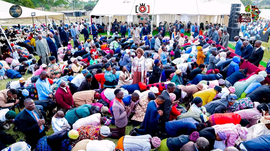 Mother Of All Revivals — large crowd kneeling in prayer